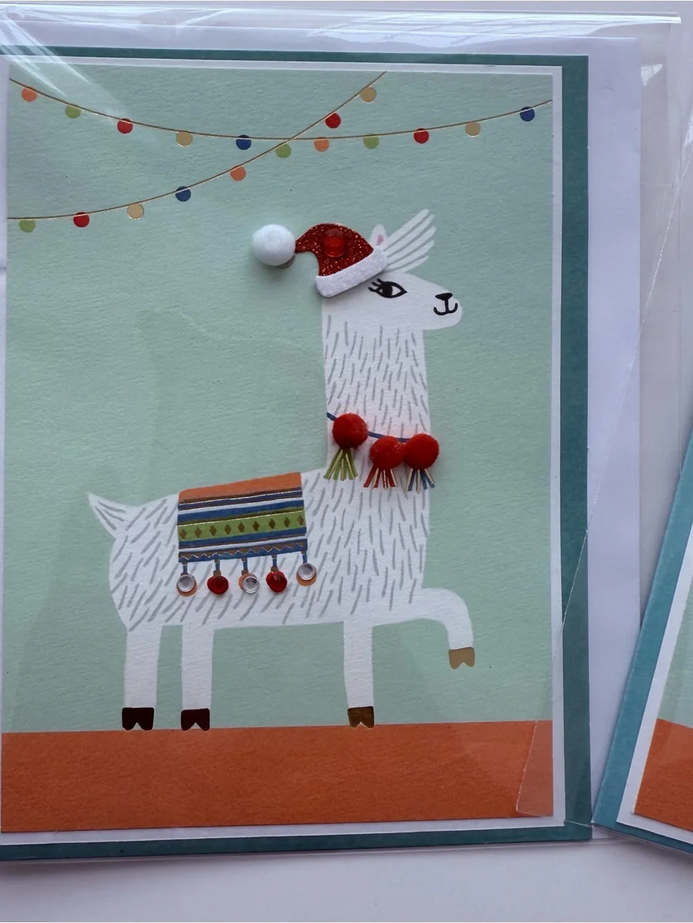 Llama Holiday Card - featuring an adorned “ticas” necklace & “aretes” blanket.